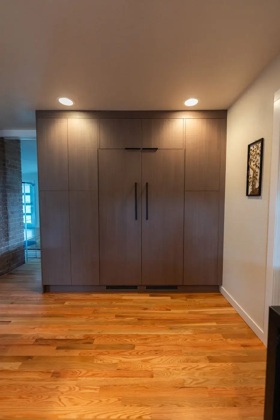 Full-height walnut pantry wall with a panel-ready refrigerator in a Kent kitchen