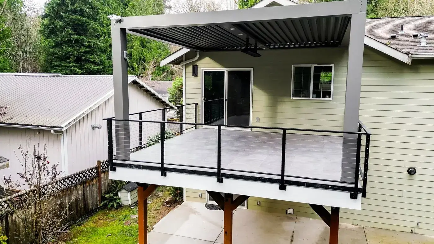 Elevated deck with a louvered cover and black railing