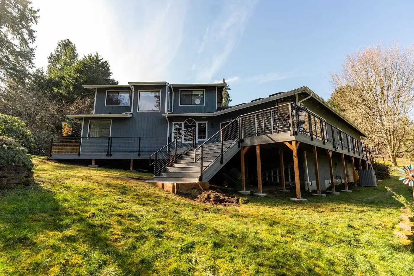 Elevated wraparound deck and stairs across the rear of the house
