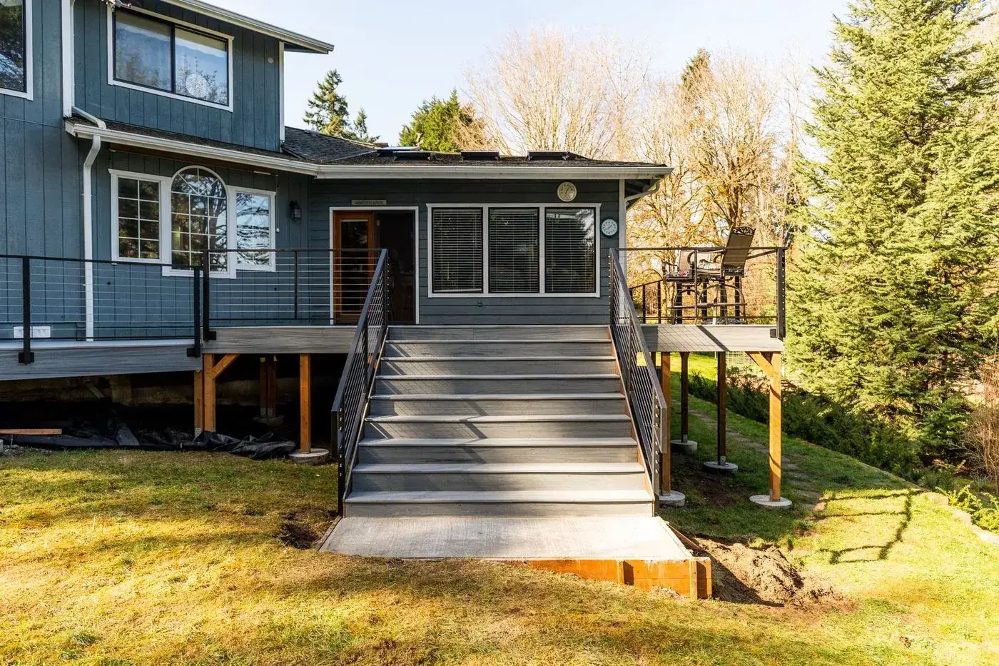 Two-level composite deck with stairs and cable railing in Olympia