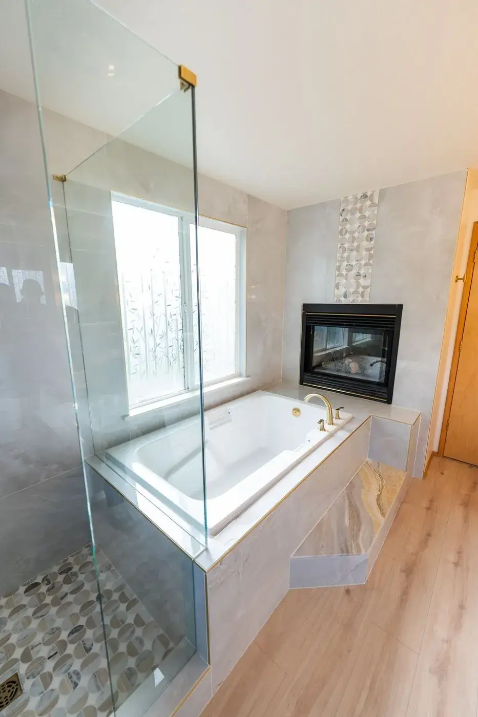 Glass shower and soaking tub in a primary bath