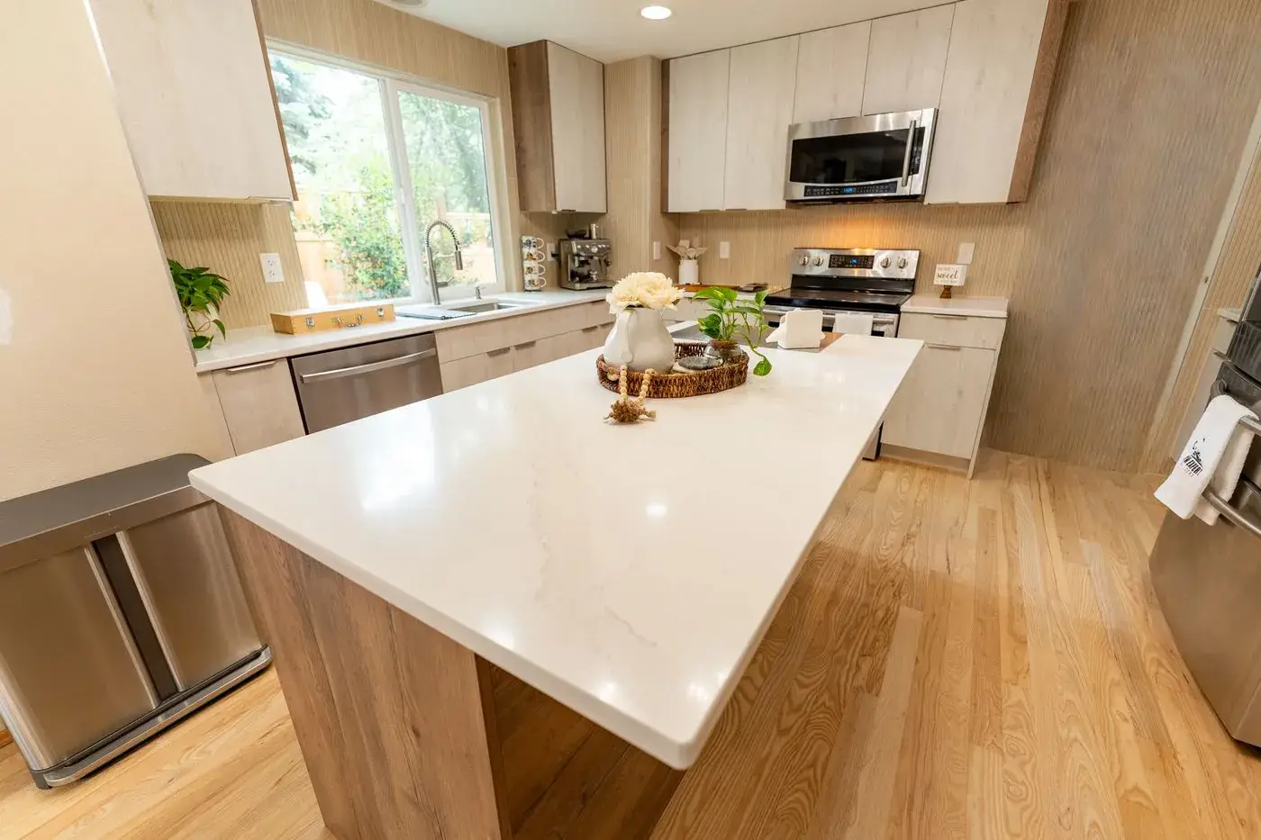Renton kitchen with light oak cabinets and a wide white quartz island
