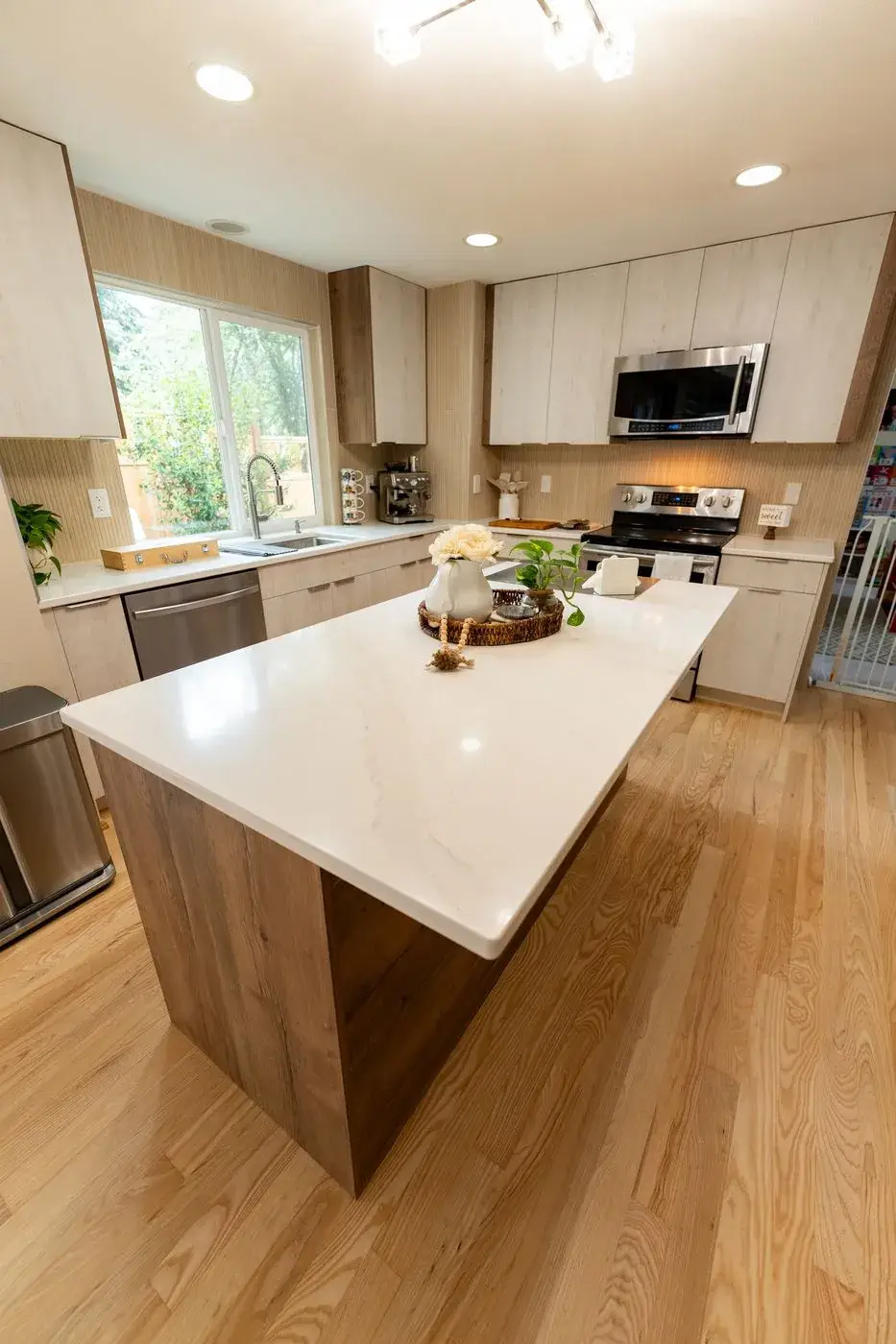 White quartz island with light oak cabinets in Renton