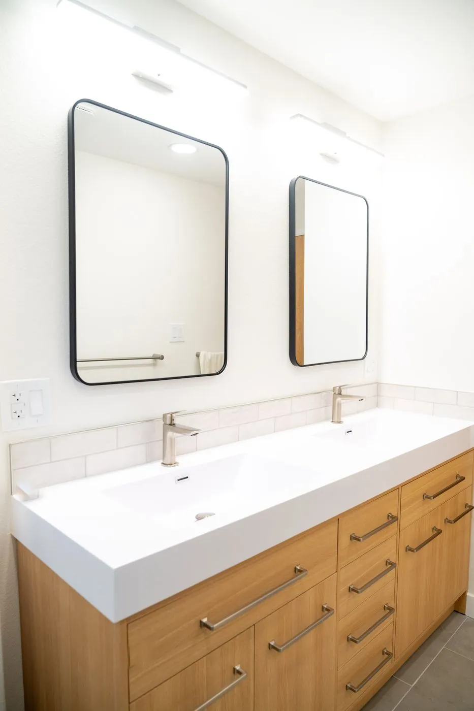 Oak double vanity with black mirrors