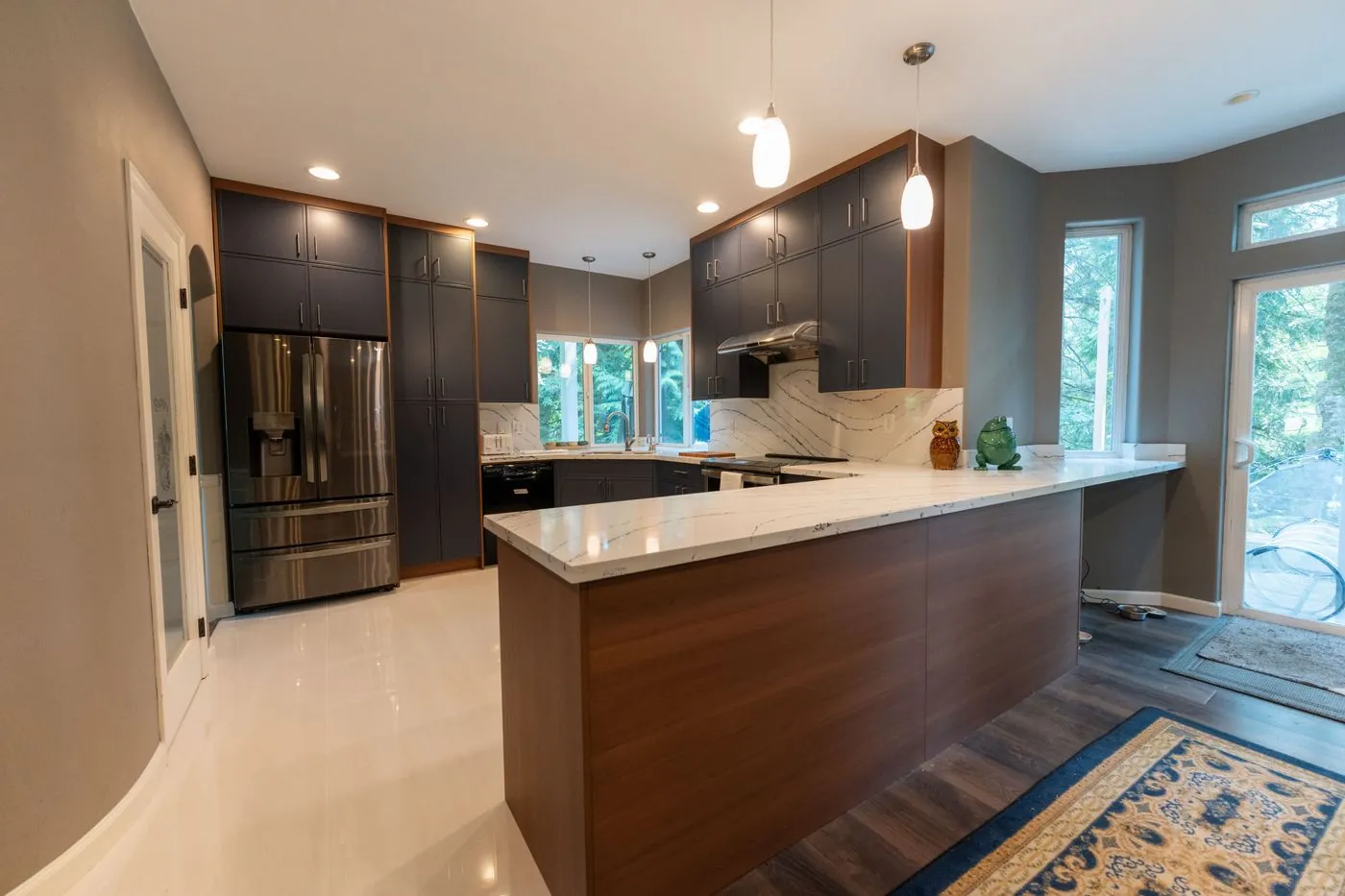Navy kitchen with a walnut peninsula