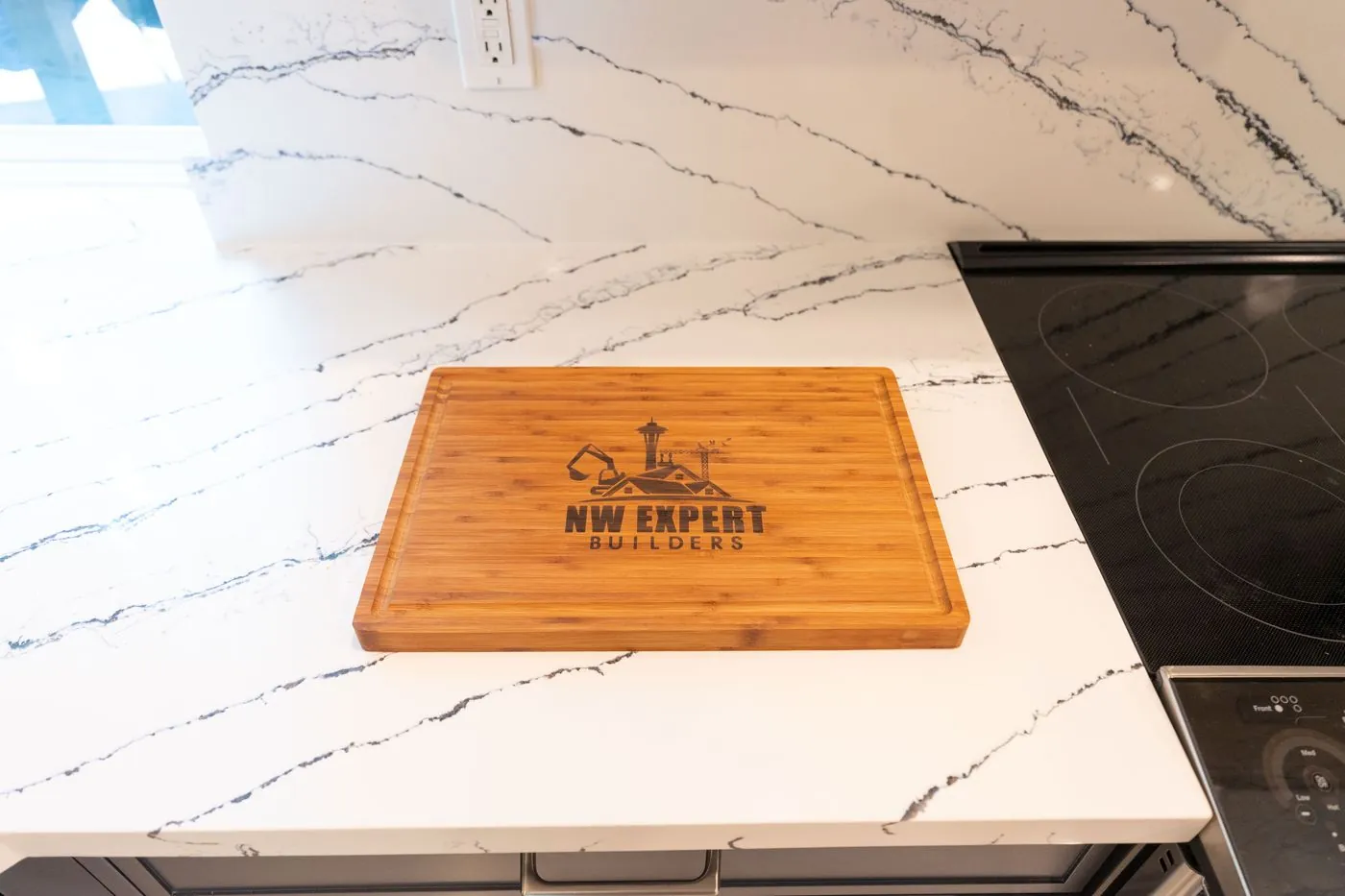 Veined quartz countertop with an NW Expert Builders cutting board
