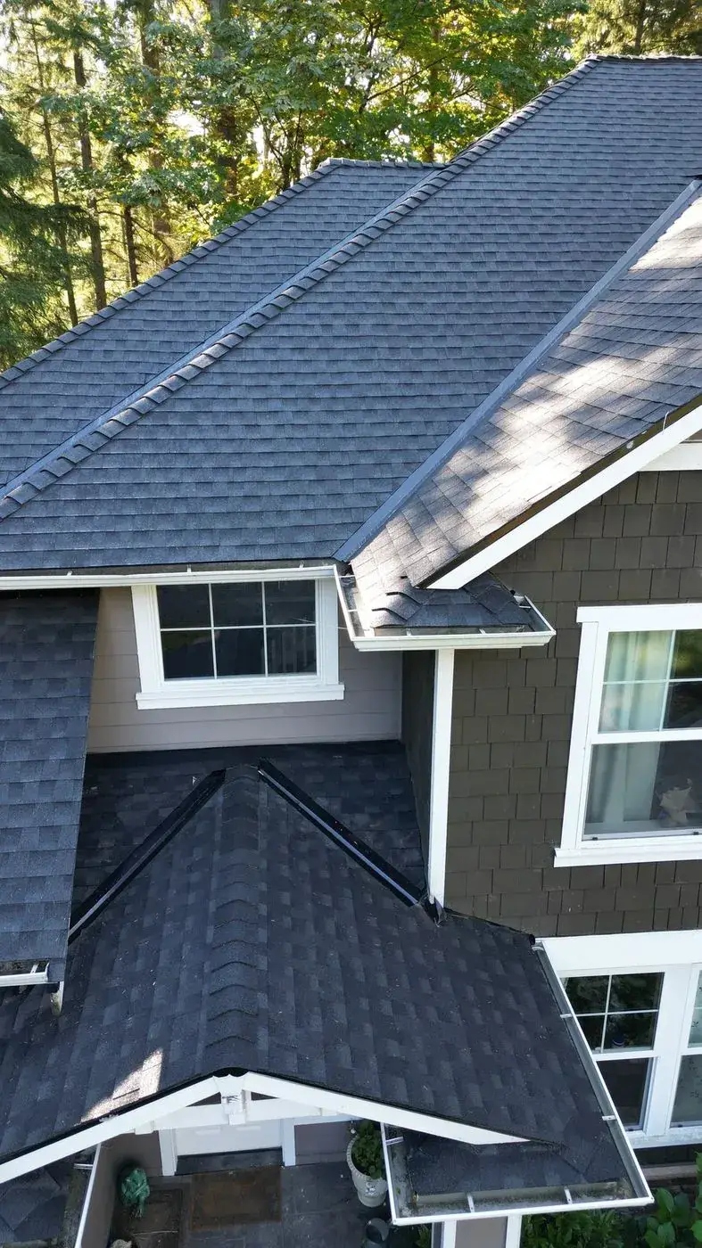 Gabled roof with new architectural shingles over a covered entry