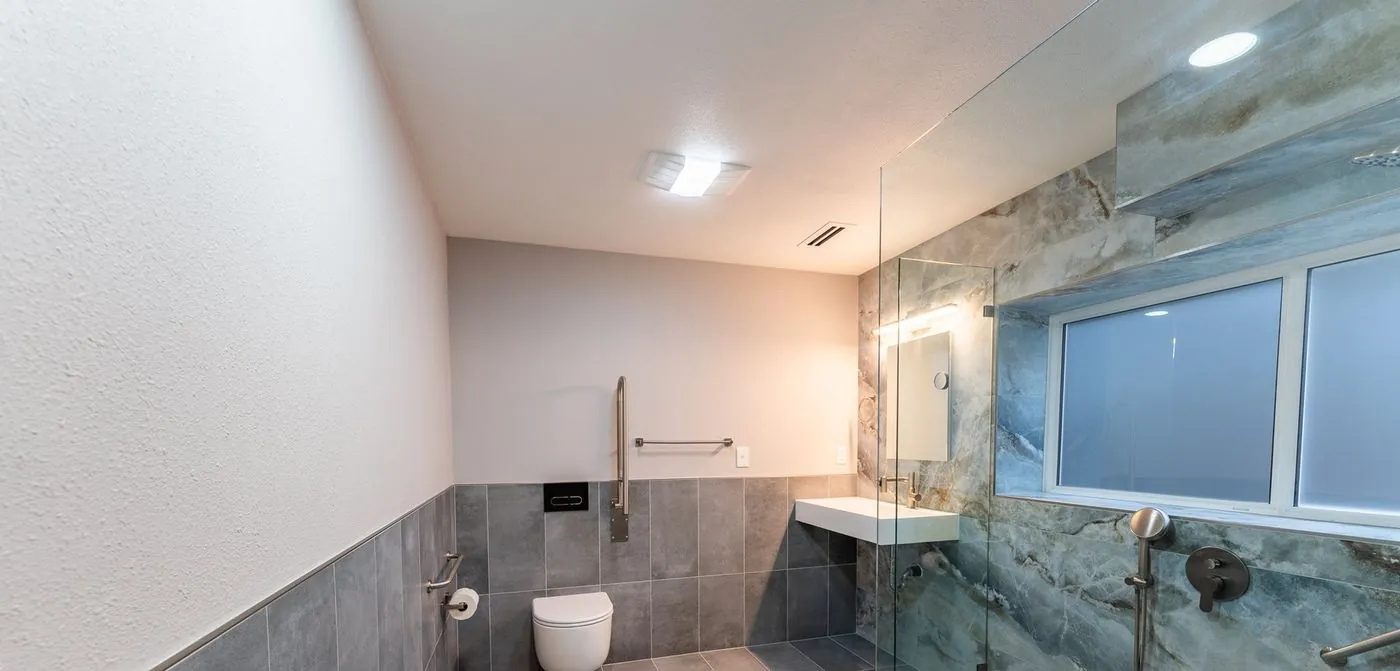 Curbless walk-in shower with grab bars in a West Seattle home