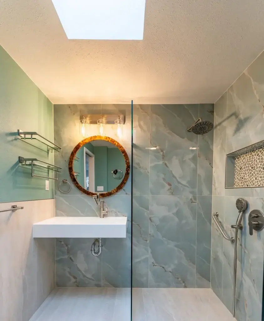 Floating sink, round mirror and green accent wall – Accessible bathrooms remodel in West Seattle, WA by NW Expert Builders