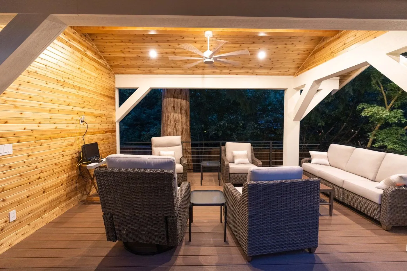 Cedar-ceilinged pavilion with lounge seating and a ceiling fan