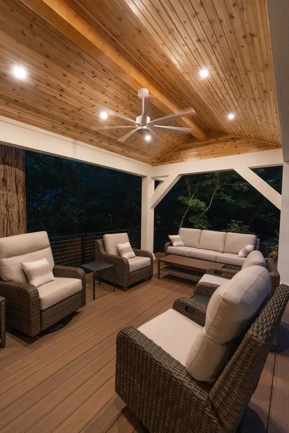 Covered cedar pavilion with lounge seating at dusk