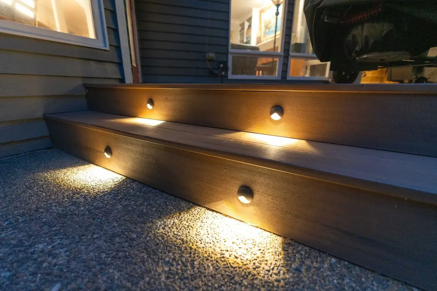 Composite deck stairs lit by step lights at night